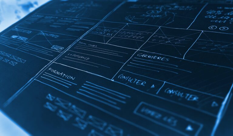A blue-tinted design board shows a website layout with handwritten notes and wireframes. Sections labeled for content, careers, and consultation are visible, with multiple boxes indicating placeholders for images and text.