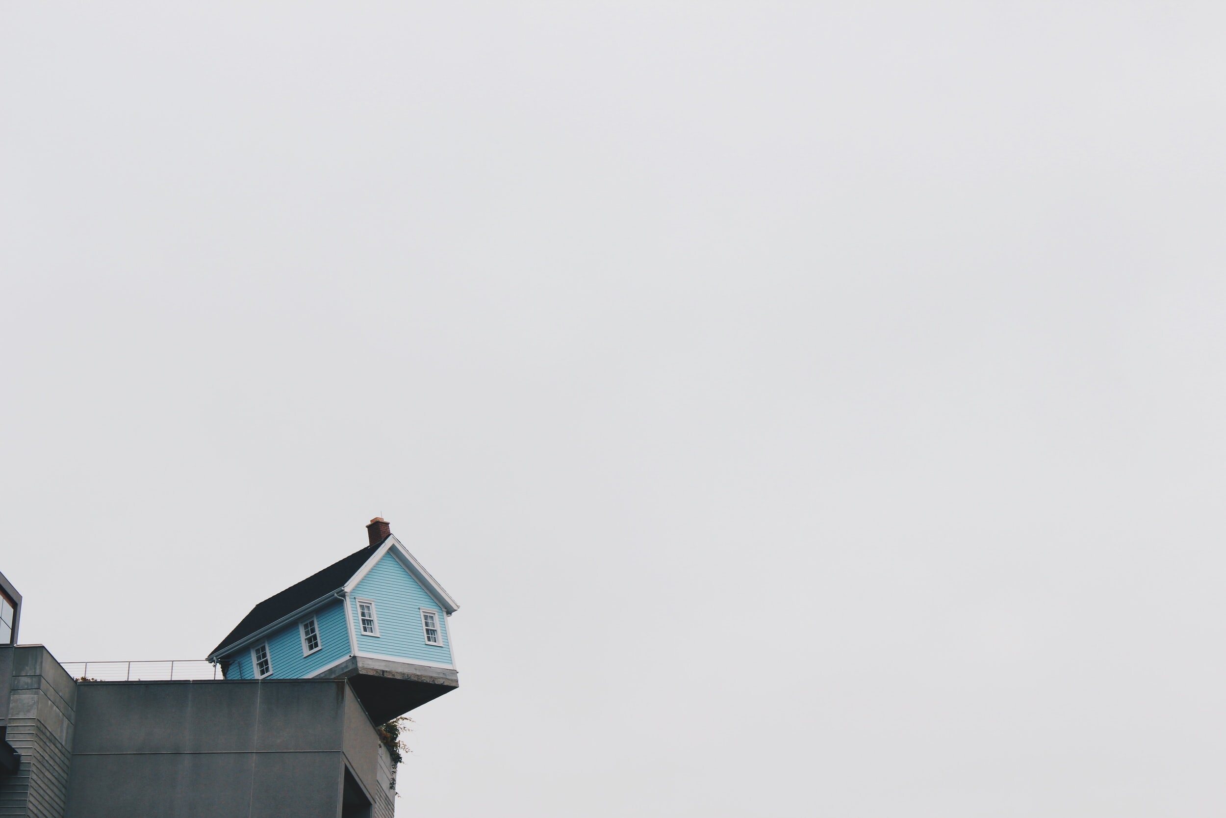 minimal image of a house on a ledge